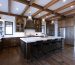 Farmhouse kitchen with wire-brushed hickory hardwood flooring and wood beam ceiling