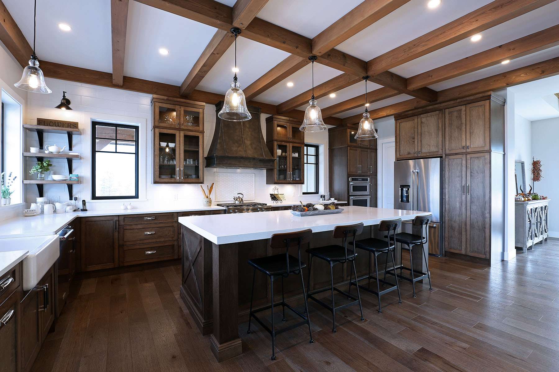 Farmhouse kitchen with wire-brushed hickory hardwood flooring and wood beam ceiling