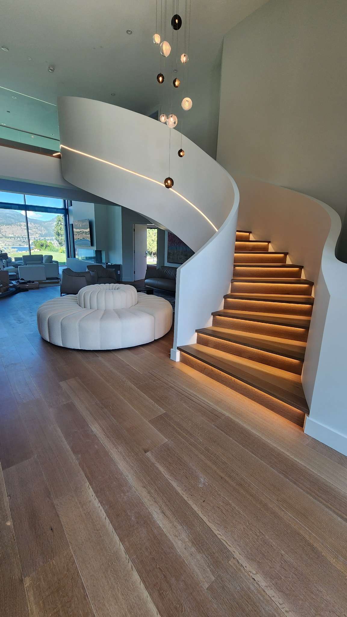 Custom curved hardwood staircase with integrated lighting