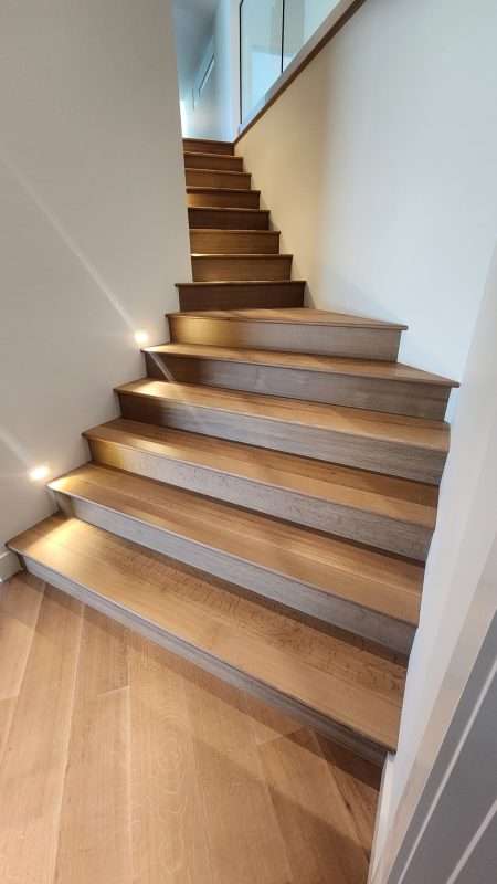 Hardwood staircase with stair lighting